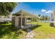 Backyard shed with carport and concrete pad surrounded by grass at 7516 S Obrien St, Tampa, FL 33616