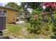 Outdoor space featuring a bright yellow exterior with mature landscaping and vintage bathtub at 7542 Armand Cir, Tampa, FL 33634
