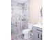 Modern bathroom featuring a marble tiled shower, gray vanity, and stylish fixtures at 7542 Armand Cir, Tampa, FL 33634