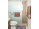 Bathroom features a glass enclosed shower with stone tile and a grab bar at 7542 Armand Cir, Tampa, FL 33634