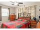 Comfortable bedroom with a ceiling fan, a dresser, and a bed with a colorful quilt at 7542 Armand Cir, Tampa, FL 33634