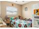 Cozy bedroom with natural light, single bed, and bright patterned bed linens at 7542 Armand Cir, Tampa, FL 33634