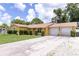 Inviting single-story home with attached two-car garage and well-maintained landscaping at 7542 Armand Cir, Tampa, FL 33634