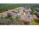 Aerial view of the neighborhood featuring a pool and pond surrounded by trees at 9481 Highland Oak Dr # 1308, Tampa, FL 33647