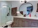 Updated bathroom features a modern vanity, a toilet, and a glass enclosed shower with updated fixtures at 9481 Highland Oak Dr # 1308, Tampa, FL 33647