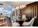 Elegant dining area with a glass-top table and modern light fixture adjacent to the kitchen at 9481 Highland Oak Dr # 1308, Tampa, FL 33647