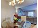 Dining area with modern light fixture, adjacent to the living room at 9481 Highland Oak Dr # 1308, Tampa, FL 33647