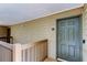 Apartment exterior with a door, stairs and a railing in a neutral color scheme at 9481 Highland Oak Dr # 1308, Tampa, FL 33647