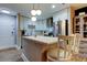 Bright kitchen with stainless-steel refrigerator and updated white cabinets and kitchen island at 9481 Highland Oak Dr # 1308, Tampa, FL 33647