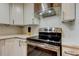 Featuring stainless-steel oven and range with white countertops and cabinets with updated hardware at 9481 Highland Oak Dr # 1308, Tampa, FL 33647