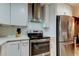 Updated kitchen features modern white cabinets, stainless steel appliances, and a decorative tile backsplash at 9481 Highland Oak Dr # 1308, Tampa, FL 33647