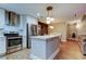 Stylish kitchen featuring stainless steel appliances, bright lighting, and an eat-in island at 9481 Highland Oak Dr # 1308, Tampa, FL 33647