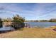 Scenic lake view featuring a wooden dock, lush trees, and a serene waterfront atmosphere at 9481 Highland Oak Dr # 1308, Tampa, FL 33647