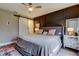 Comfortable main bedroom boasts a ceiling fan, barn door to the main bath, and decorative accent wall at 9481 Highland Oak Dr # 1308, Tampa, FL 33647