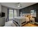 Sunlit main bedroom offers tranquil views of nature through updated windows with curtains and a ceiling fan at 9481 Highland Oak Dr # 1308, Tampa, FL 33647