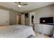 Bright main bedroom showcases a ceiling fan, a television, and an en suite bath for convenience at 9481 Highland Oak Dr # 1308, Tampa, FL 33647