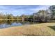 A tranquil pond reflecting the surrounding trees, adding a touch of nature to the property at 9481 Highland Oak Dr # 1308, Tampa, FL 33647