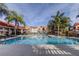 Resort-style pool surrounded by palm trees and lounge chairs offering a relaxing retreat at 9481 Highland Oak Dr # 1308, Tampa, FL 33647