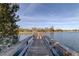 Charming wooden dock extending into the lake with scenic waterfront and blue sky views at 9481 Highland Oak Dr # 1308, Tampa, FL 33647
