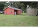 Property featuring a house, a utility shed, and a large grass backyard at 1006 Gray St, Plant City, FL 33563