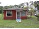 Charming single-story home featuring a cozy front porch and well-maintained lawn at 1006 Gray St, Plant City, FL 33563