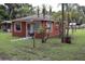 Quaint single-story house with a mailbox, and mature trees in the front yard at 1006 Gray St, Plant City, FL 33563