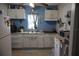 Bright kitchen with white cabinets, blue walls, and modern appliances at 1006 Gray St, Plant City, FL 33563