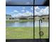 View from screened in lanai, showing backyard, pond, and other homes in the community at 10109 36Th E Ct, Parrish, FL 34219
