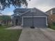 Attractive house with a two-car garage, green lawn, and a basketball hoop in the driveway at 10109 36Th E Ct, Parrish, FL 34219