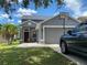 Well-maintained home with an attached two-car garage, green lawn, and driveway with space for cars at 10109 36Th E Ct, Parrish, FL 34219