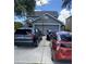 A house with a full driveway and three cars parked on it at 10109 36Th E Ct, Parrish, FL 34219