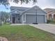 Charming single-story home with a gray exterior, well-manicured lawn, and a two-car garage at 10109 36Th E Ct, Parrish, FL 34219
