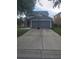 A house with palm trees, a gray exterior, and a well-manicured lawn with rock features at 10109 36Th E Ct, Parrish, FL 34219