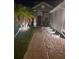 Well-lit front entrance with palm trees and gravel landscaping adds curb appeal at nighttime at 10109 36Th E Ct, Parrish, FL 34219