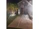 Well-lit front entrance with palm trees and gravel landscaping adds curb appeal at nighttime at 10109 36Th E Ct, Parrish, FL 34219