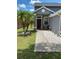 A charming home featuring a welcoming front entrance, with palm trees and landscaped rock accents at 10109 36Th E Ct, Parrish, FL 34219
