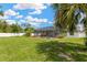 Large, fully fenced backyard featuring a screened lanai with an inground pool on an expansive green lawn at 10811 Providence Oaks Dr, Riverview, FL 33578
