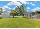 Spacious backyard featuring a storage shed, well-manicured lawn, and access to a screened-in patio at 10811 Providence Oaks Dr, Riverview, FL 33578