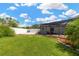 Large backyard with a screened-in porch featuring a brick patio, great for outdoor living at 10811 Providence Oaks Dr, Riverview, FL 33578