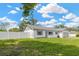 Charming home with white exterior, gray accents, and a well-manicured lawn for great curb appeal at 10811 Providence Oaks Dr, Riverview, FL 33578