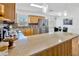 Well-lit kitchen featuring stainless steel appliances, a mosaic backsplash, and an open breakfast bar area at 10811 Providence Oaks Dr, Riverview, FL 33578