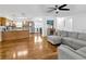 Open-concept living area featuring hardwood floors with a view of the kitchen and stainless-steel appliances at 10811 Providence Oaks Dr, Riverview, FL 33578