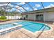 Backyard features a sparkling pool and hot tub with an expansive screened patio at 10811 Providence Oaks Dr, Riverview, FL 33578