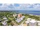 An aerial view highlights the building's location near a beautiful beach and serene coastline with clear blue waters and lush landscaping at 1120 N Shore Ne Dr # 503, St Petersburg, FL 33701