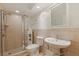 Elegant bathroom showcasing a tiled shower, sleek toilet, and pedestal sink offering style and convenience at 1120 N Shore Ne Dr # 503, St Petersburg, FL 33701
