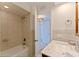 Well-lit bathroom featuring a tub with shower, tiled walls, and a vanity with marble countertop at 1120 N Shore Ne Dr # 503, St Petersburg, FL 33701