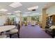 Community room featuring large windows, tables, chairs, and sofas at 1120 N Shore Ne Dr # 503, St Petersburg, FL 33701