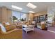 Bright community room with comfortable seating, a bookshelf, and large windows offering serene views at 1120 N Shore Ne Dr # 503, St Petersburg, FL 33701