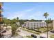 A condo building on a tree-lined street shows a charming and convenient residential setting at 1120 N Shore Ne Dr # 503, St Petersburg, FL 33701