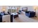 Cozy living room with carpet, access to the balcony, comfortable seating, and a mounted TV at 1120 N Shore Ne Dr # 503, St Petersburg, FL 33701